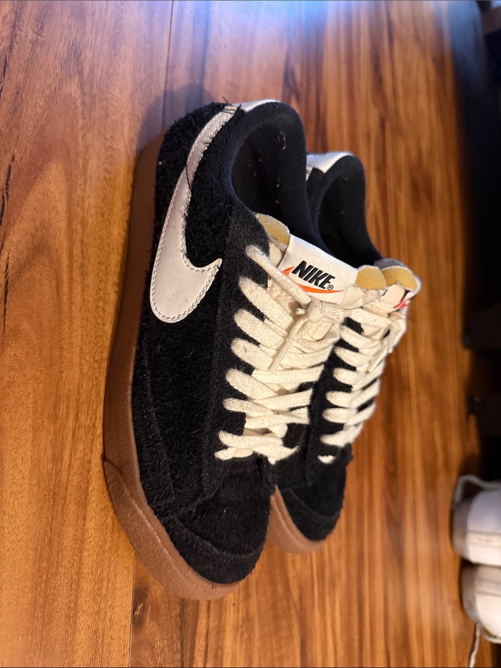 Nike Black Suede Sneakers with White Swoosh and Gum Sole